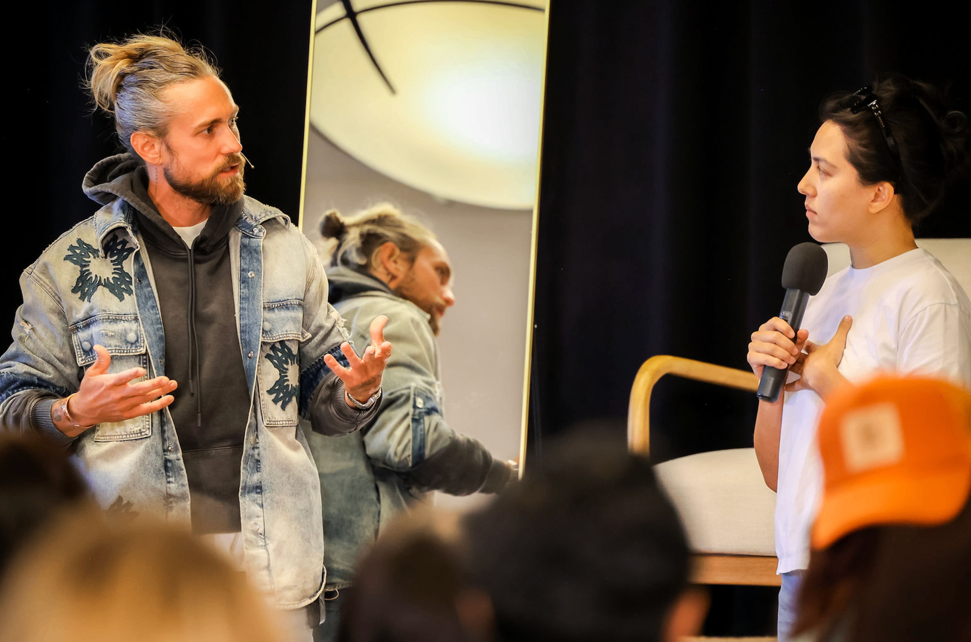 Aaron coaching a participant on stage
